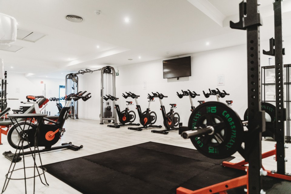 Gym with exercise bikes and weight racks
