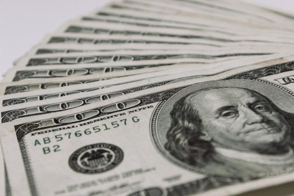 Fan of dollar bills on a light background