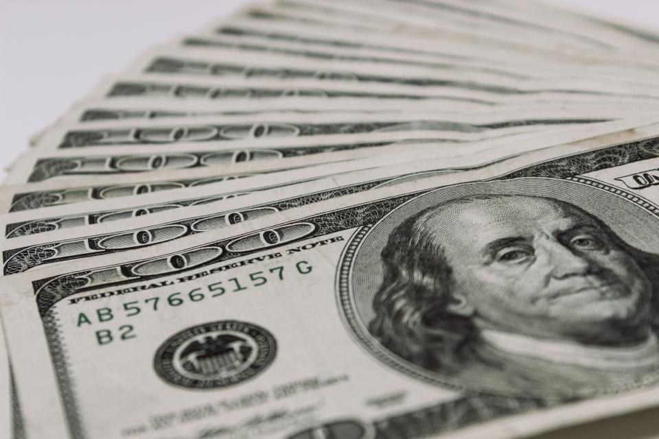 Fan of dollar bills on a light background