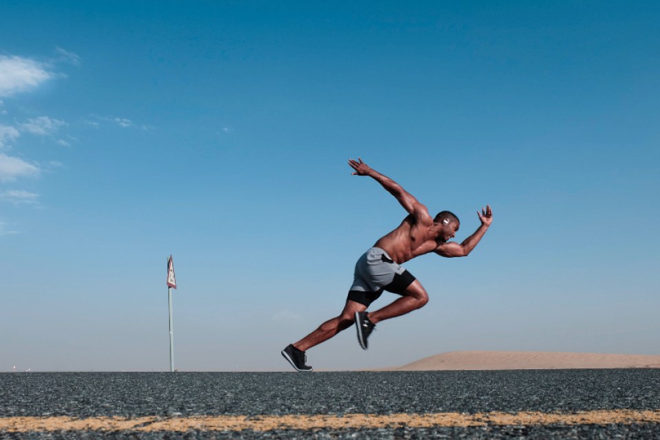Sprinter at full stretch on a flat open track