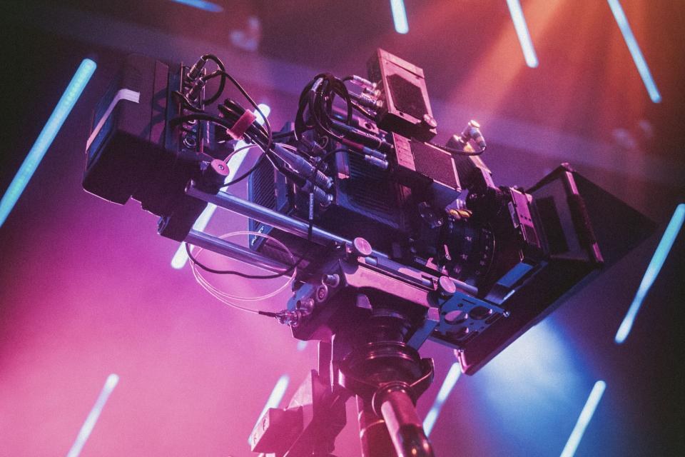 Camera on a rig in a studio with pink and blue lights
