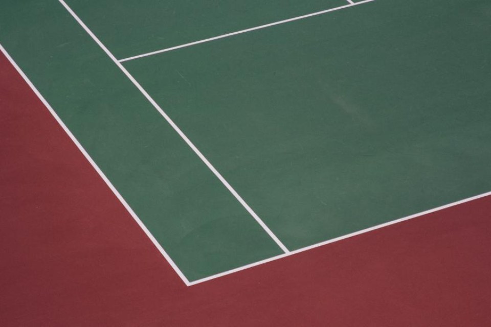 Green and red hard tennis court with white lines